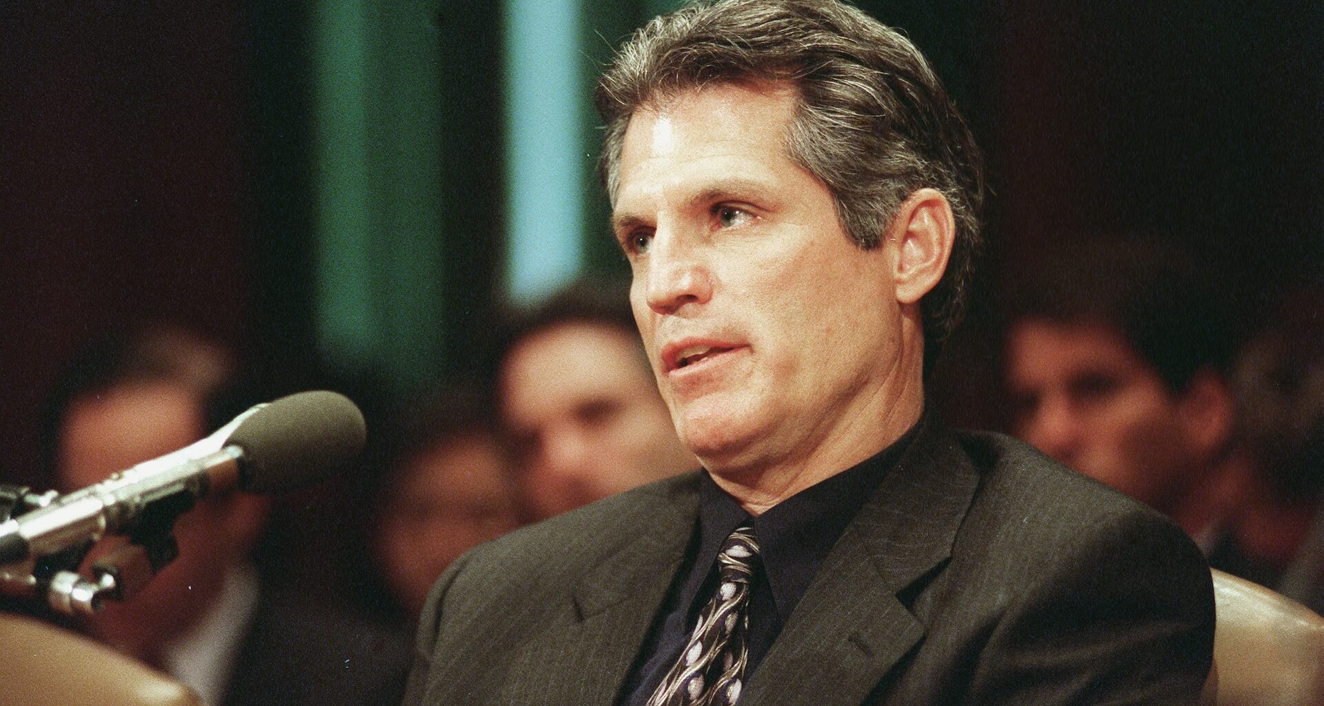 Paul Gelsinger speaks into a microphone