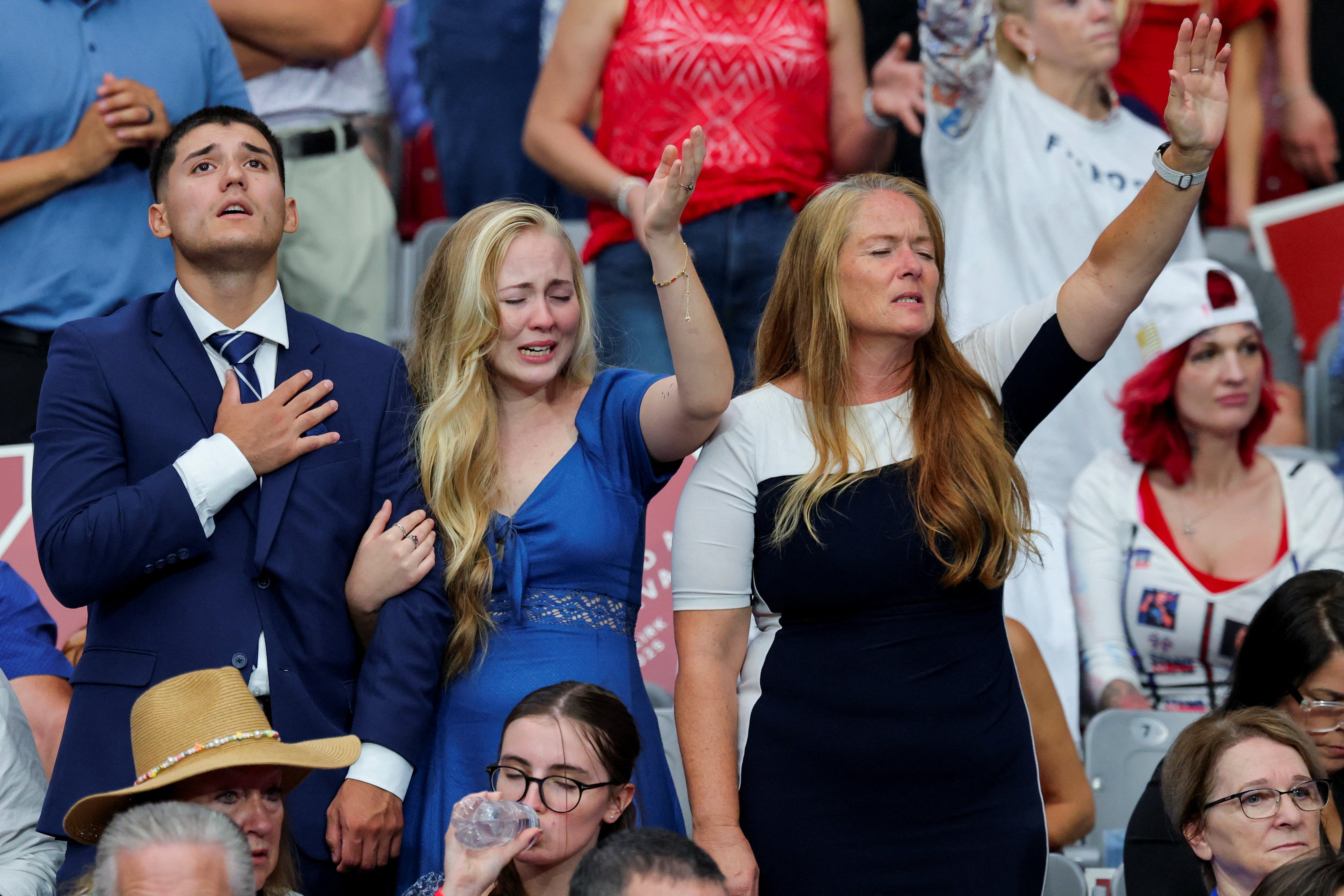 People gather at the memorial for Kirk
