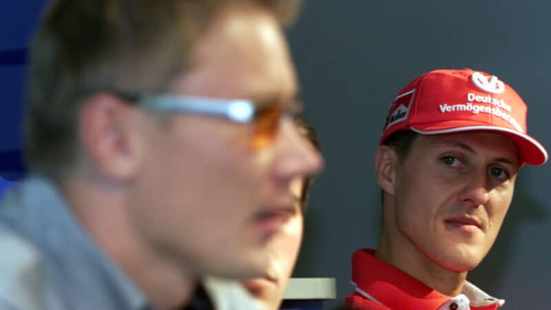 Michael Schumacher looks across at Mika Hakkinen.ahead of the 2000 F1 Italian Grand Prix at Monza