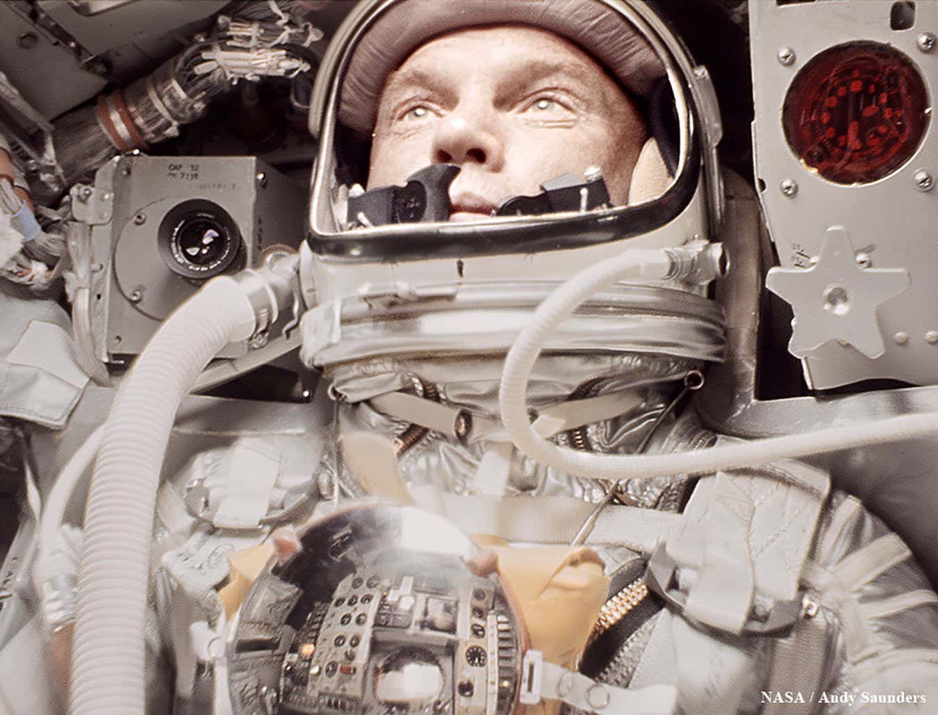 John Glenn during the fiery re-entry, holding steadfast, believing his heatshield had come loose and he may burn up in the atmosphere - the capsule is illuminated in orange light due to intense heat.