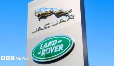 A black Range Rover on a car production line