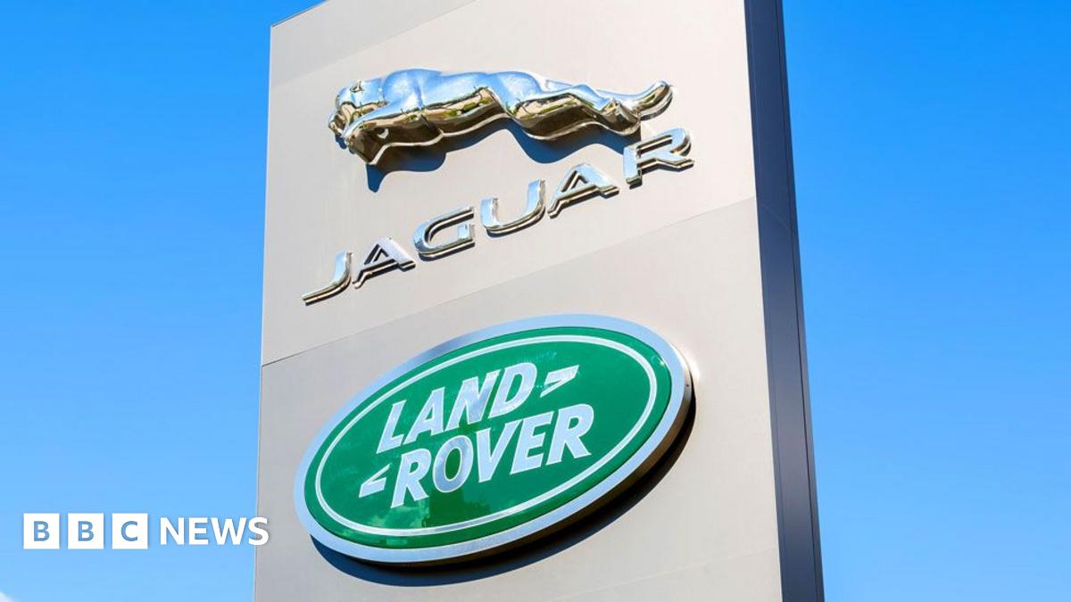 A black Range Rover on a car production line