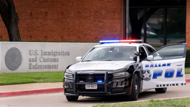 A Dallas police care outside the ICE facility
