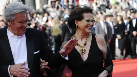 Getty Images Cardinale (right) at Cannes Film Festival 2010, with French actor Alain Delon (left). 