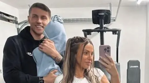 Holly Hagan-Blyth Holly, her husband and baby at the gym