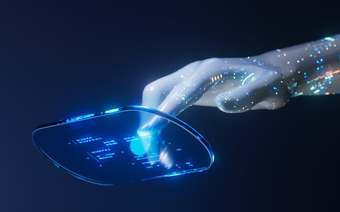 An artificially generated hand tapping on a clear digital surface suspended in the air.