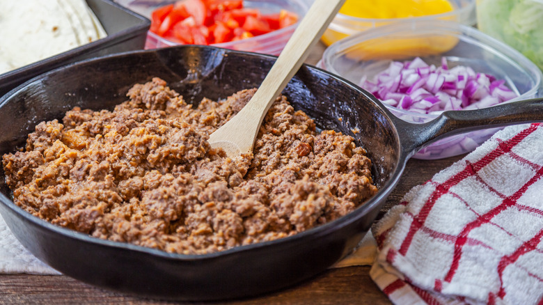 Ground beef simmering in a pan