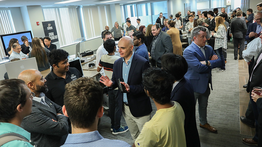 People standing and talking in a conference room