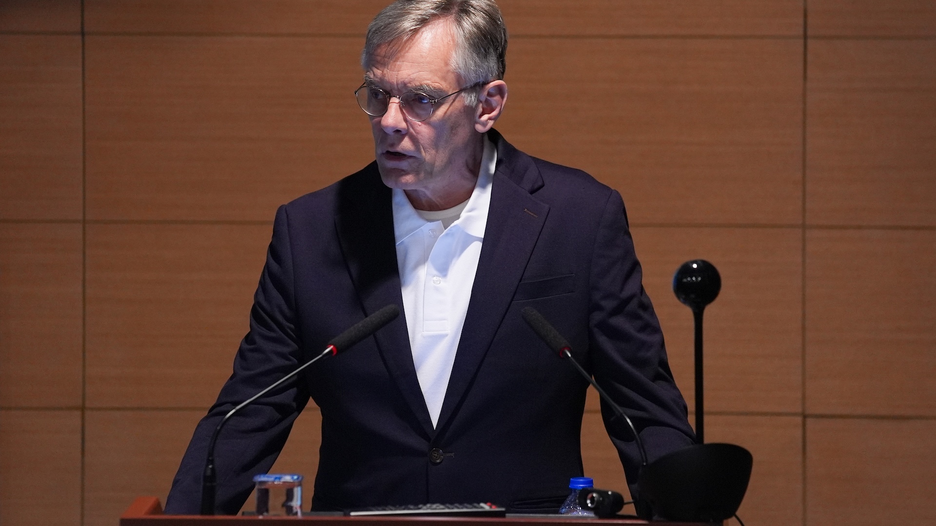 James Wilson gives a speech from a podium