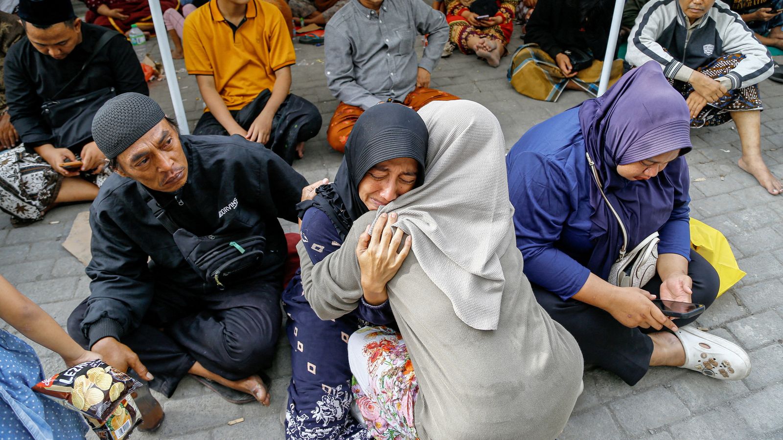 Relatives wait to hear news of their loved ones. Pic: Reuters.