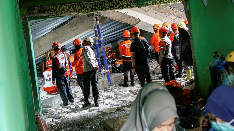 Search and rescue officers at the scene. Pic: Reuters