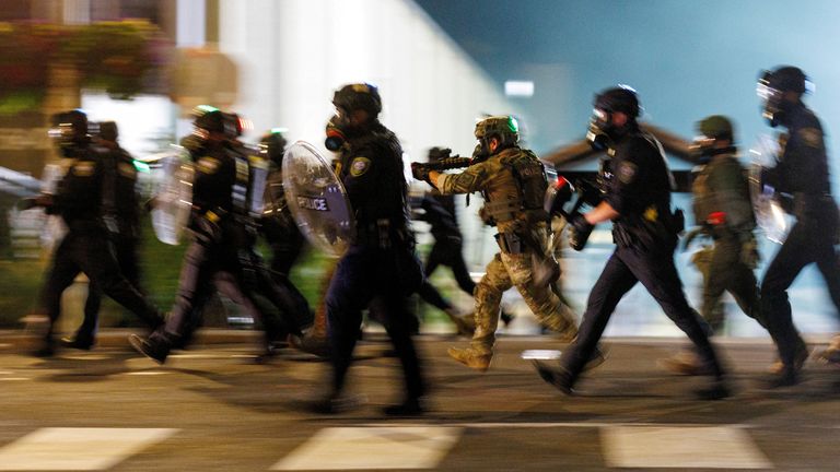ICE agents charge towards protesters in Portland in June. Pic: Reuters