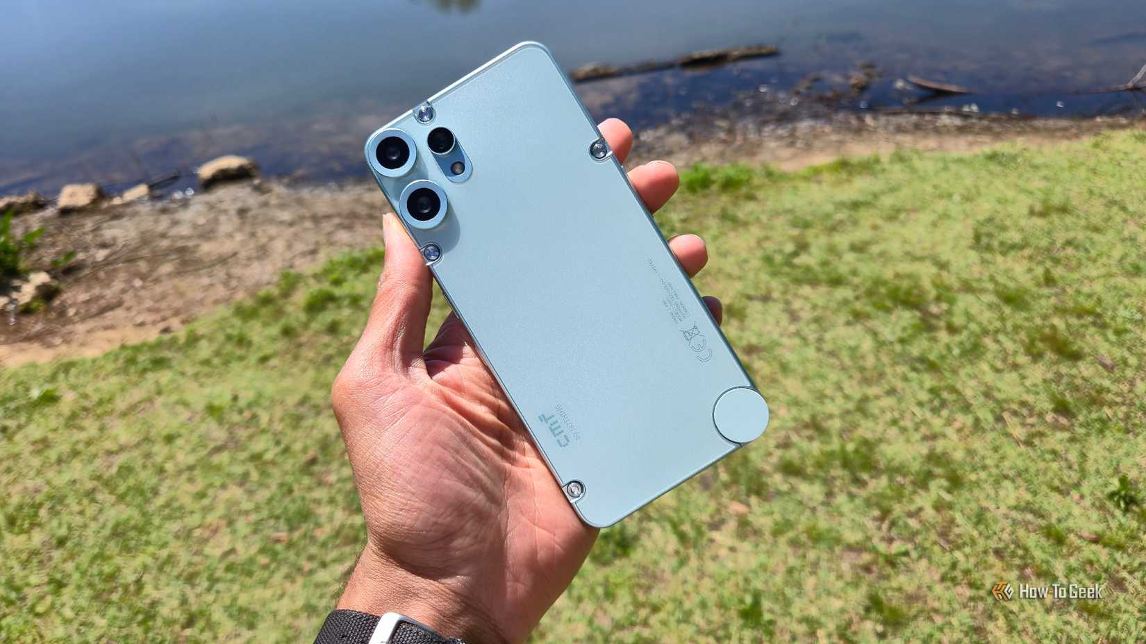 The CMF Phone 2 Pro in front of a lake.