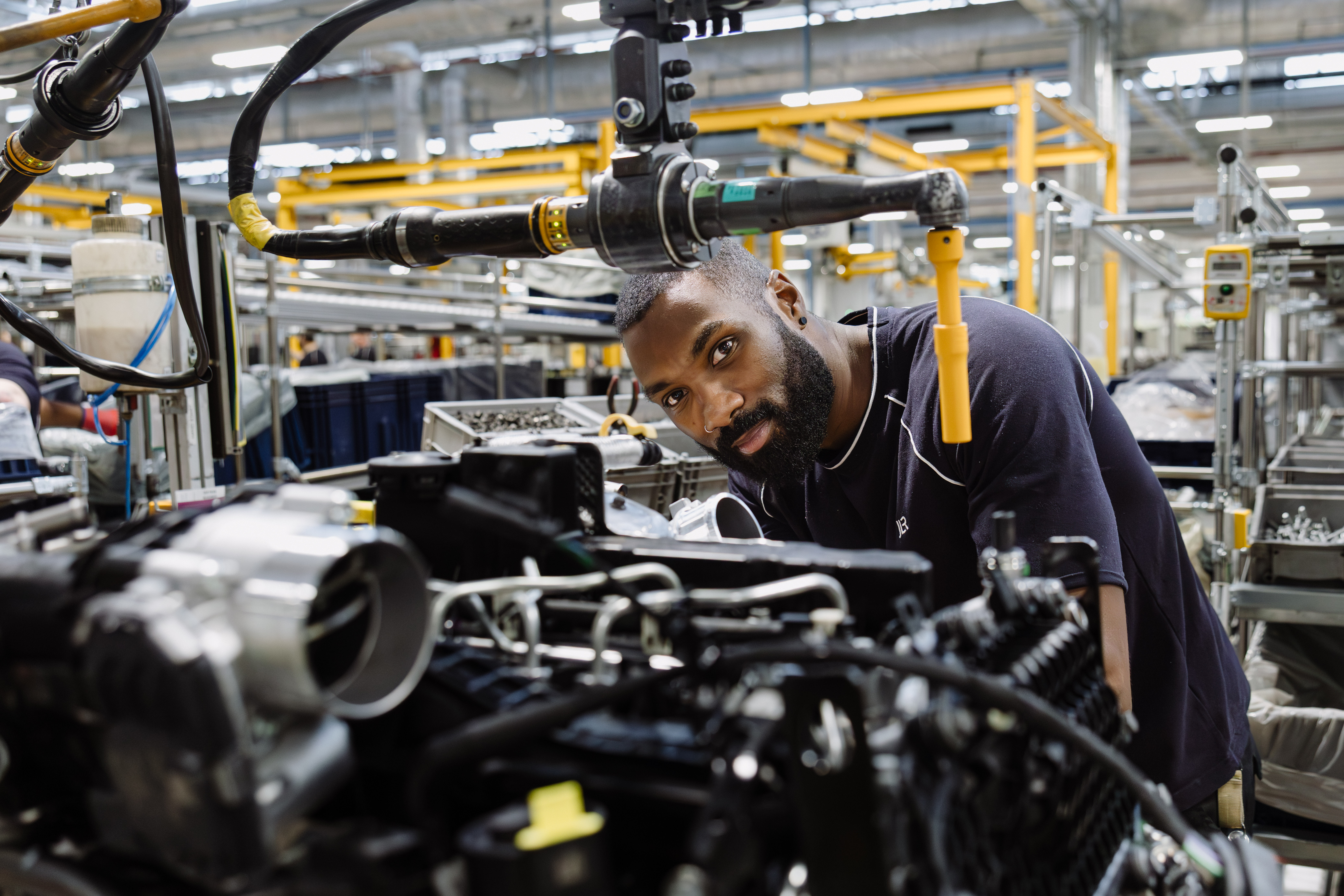 A team leader at JLR’s Electric Propulsion Manufacturing Centre working on an engine production line.