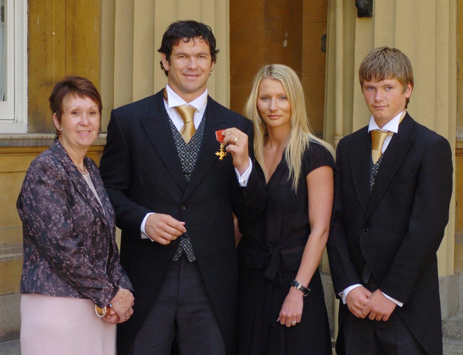 Rugby Union's Andy Farrell celebrates becoming an Officer of the Most Excellent Order of the British Empire (OBE) with his mother Carol, wife Colleen, and son Owen.