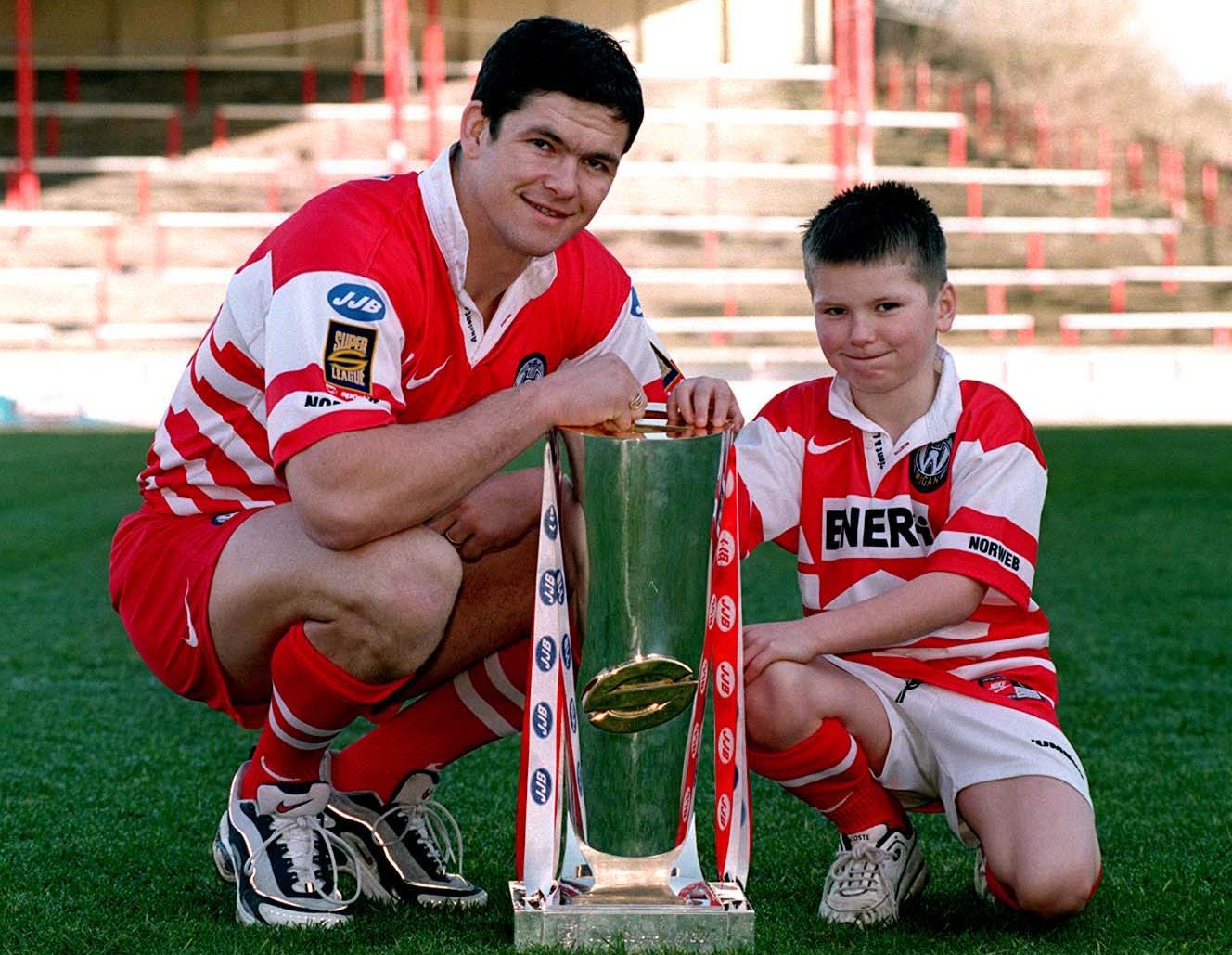 Wigan Rugby League captain Andy Farrell and son Owen Farrell pose with the Super League trophy.