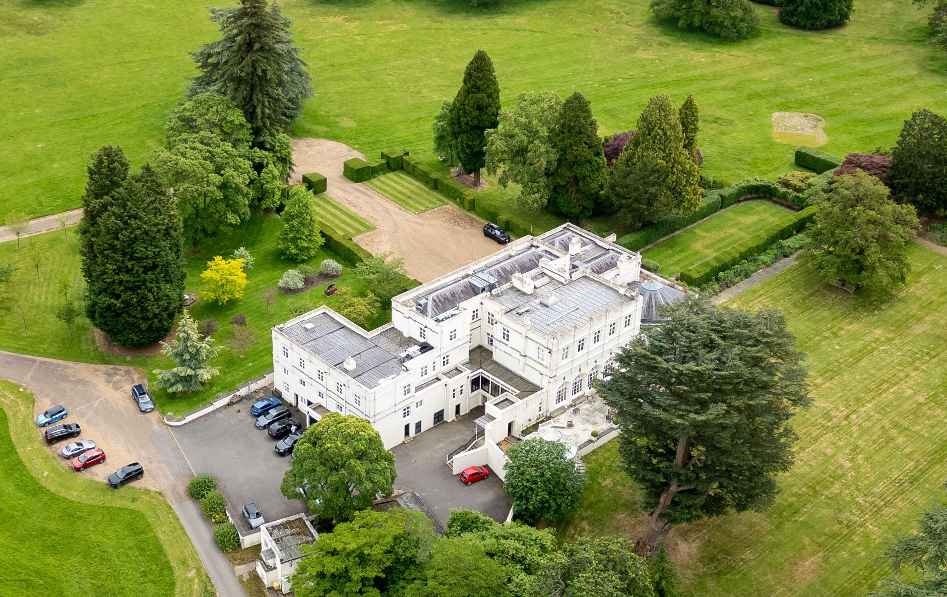 Royal Lodge in Windsor Great Park, the home of Prince Andrew, surrounded by green lawns and trees.