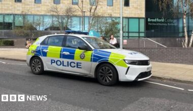 Police car parked at the scene outside Bradford College on Great Horton Road.
