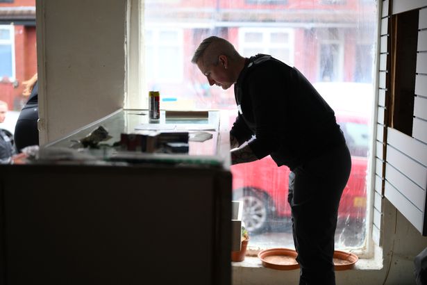 Police search the store on Stamford Road