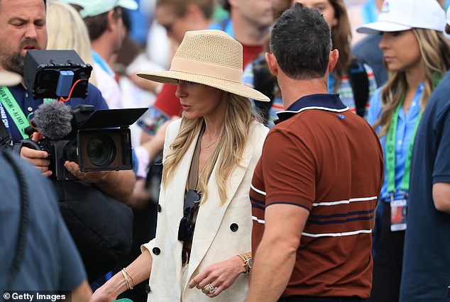 McIlroy's partner was even hit by a drink during a volatile final day of the tournament