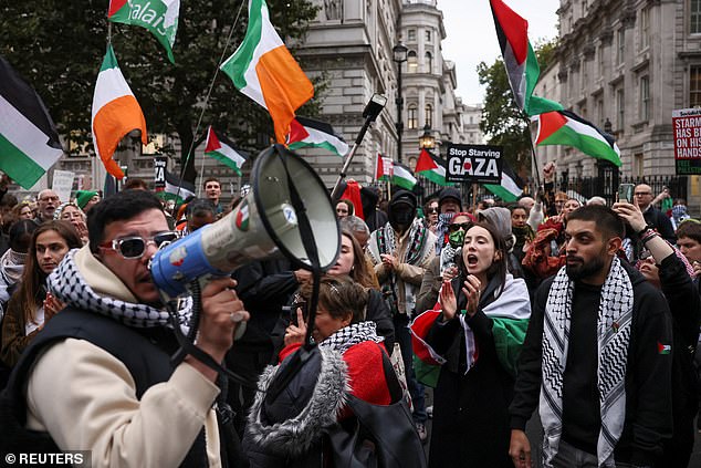 A demonstrator speaks through a megaphone during a pro-Palestine protest in Parliament Square on Yom Kippur, the holiest day in the Jewish calendar