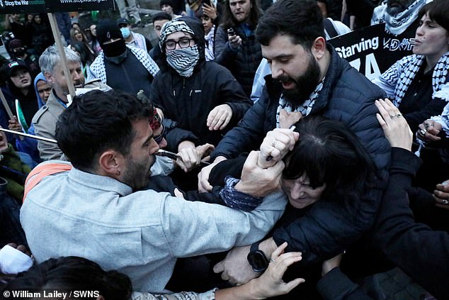 People scuffle amid a pro-Palestinian march in Manchester centre on the day a knifeman killed two people at a synagogue in the city