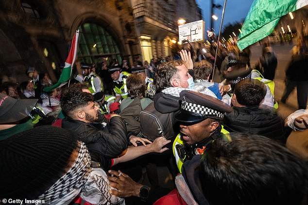 Police scuffle with protestors at the south end of Whitehall following a protest in Parliament square on Thursday