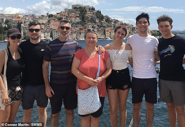 His brother Connor, 29, is now raising awareness around meningitis after the family initially put Lucas's bad headaches and fever-like symptoms down to fresher's flu (Pictured: Lucas, right, with his family)