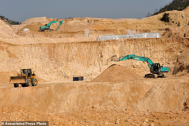 Workers use machinery to dig at a rare earth mine in Ganxian county in central China's Jiangxi province. China dominates the global rare earth supply chain, and the US is heavily dependent on imports