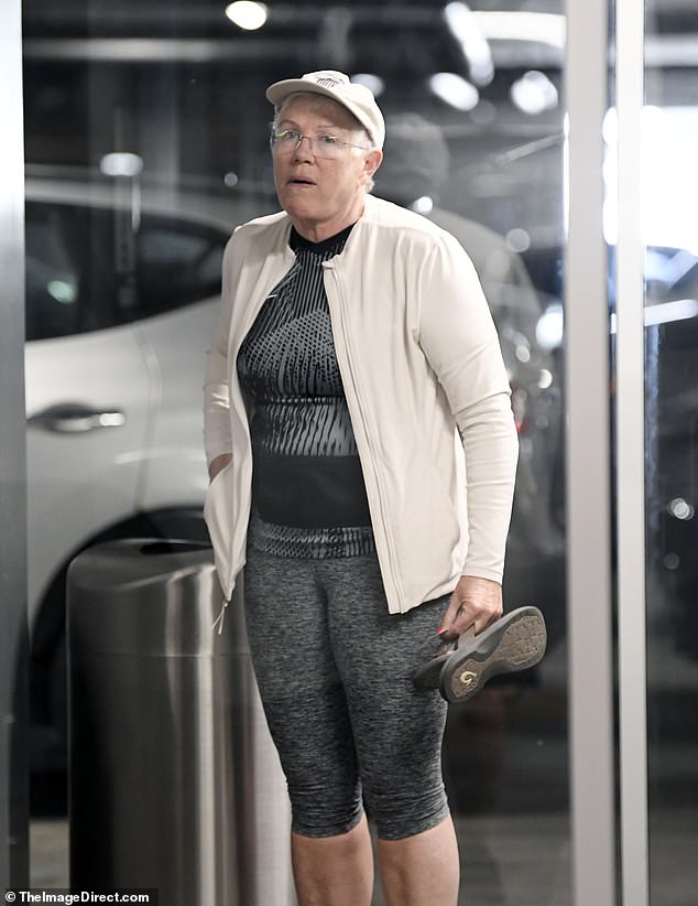 Sweeney was seen in a car garage in Los Angeles in a carefully coordinated gym ensemble, featuring gray and black capri leggings and a matching halter top, paired with a cream-colored zip-up