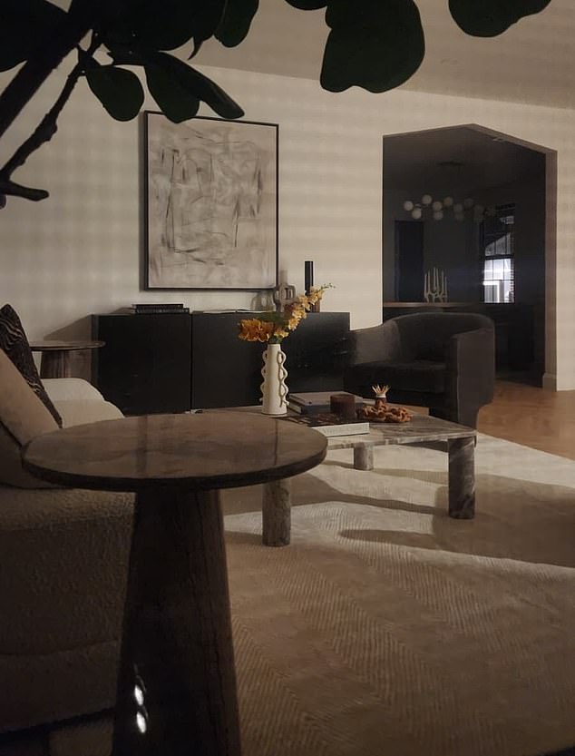 A staging company set up the home's interior with modern furniture and accessories, including a mid-century modern light fixture, swivel accent chairs and wall art