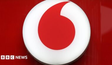 Vodafone's red and white logo displayed in a close-up shot of a storefront's sign.