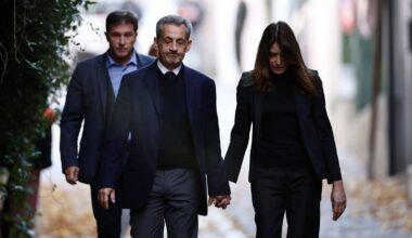 Nicolas Sarkozy leaves his house with his wife Carla Bruni-Sarkozy. Pic: Reuters