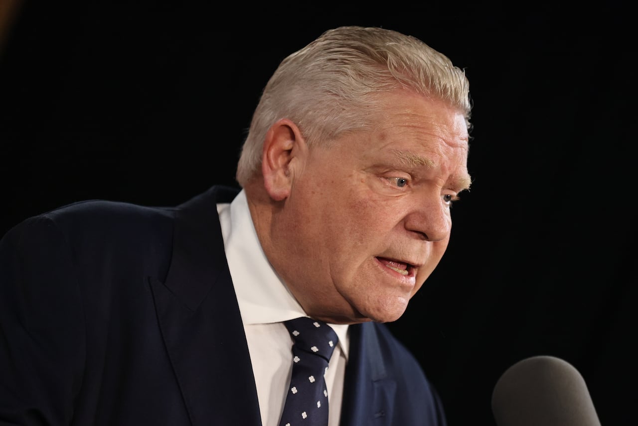 A headshot of Ontario Premiere Doug Ford speaking into a microphone
