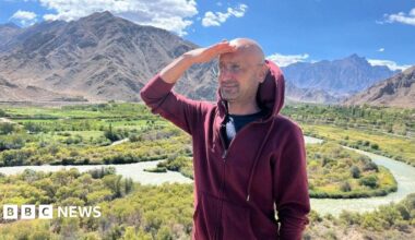 Jensen Huang, CEO of Nvidia, speaks during a news conference in Taipei in May. He is pictured holding a semiconductor unit while addressing the crowd.
