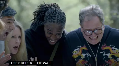 A scene from Celebrity Traitors around a well