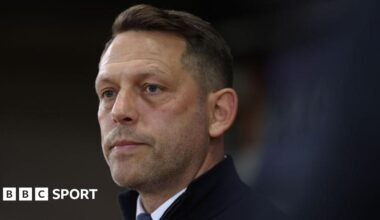 Leam Richardson looks on while stood in the Rotherham dugout