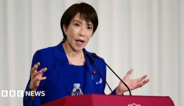 Jensen Huang, CEO of Nvidia, speaks during a news conference in Taipei in May. He is pictured holding a semiconductor unit while addressing the crowd.