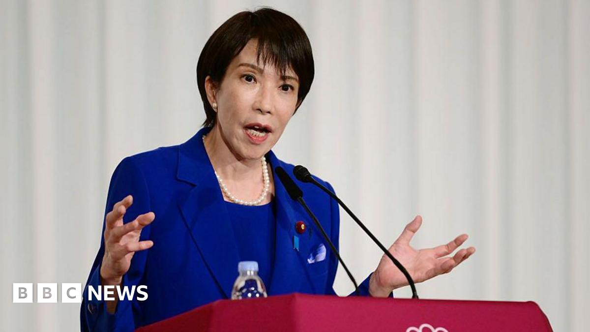 Jensen Huang, CEO of Nvidia, speaks during a news conference in Taipei in May. He is pictured holding a semiconductor unit while addressing the crowd.