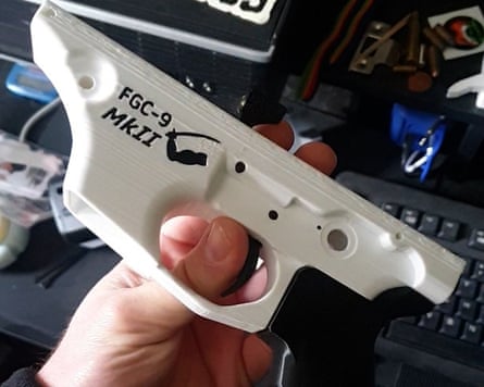 Someone holding a white plastic object that resembles the main body of a handgun