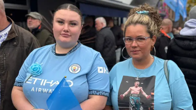 Vanessa Stansfield is standing next to her friend Emily outside the pub. She is wearing a blue T-shirt with a photograph of Ricky Hatton in the boxing ring