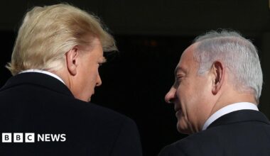 Trump is on the left with his back to the camera, looking right towards Netanyahu who is also with his back to the lens, looking left towards Trump. Both men have dark suits and white shirts