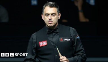 Ronnie O'Sullivan holds a snooker cue