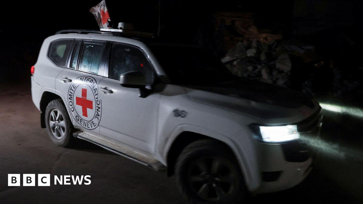 A white Red Cross jeep with the emblem of a red cross and the organisation's name on the side.