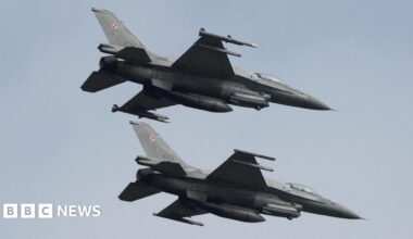 Two Polish F-16 fighter jets flying side by side