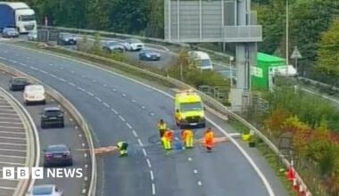 Motorway with workers seen in the lanes and piles of sand in a number of areas.