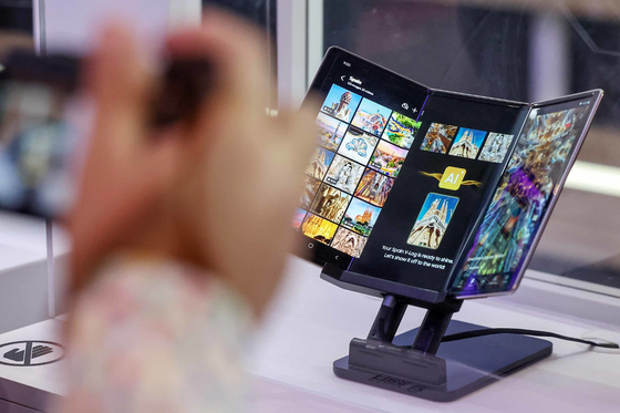 Visitors to the Mobile World Congress (MWC) 2025 examine a prototype of the Flex G at the Samsung Display booth at the Fira de Barcelona exhibition center in Barcelona, Spain on March 6. [NEWS1]