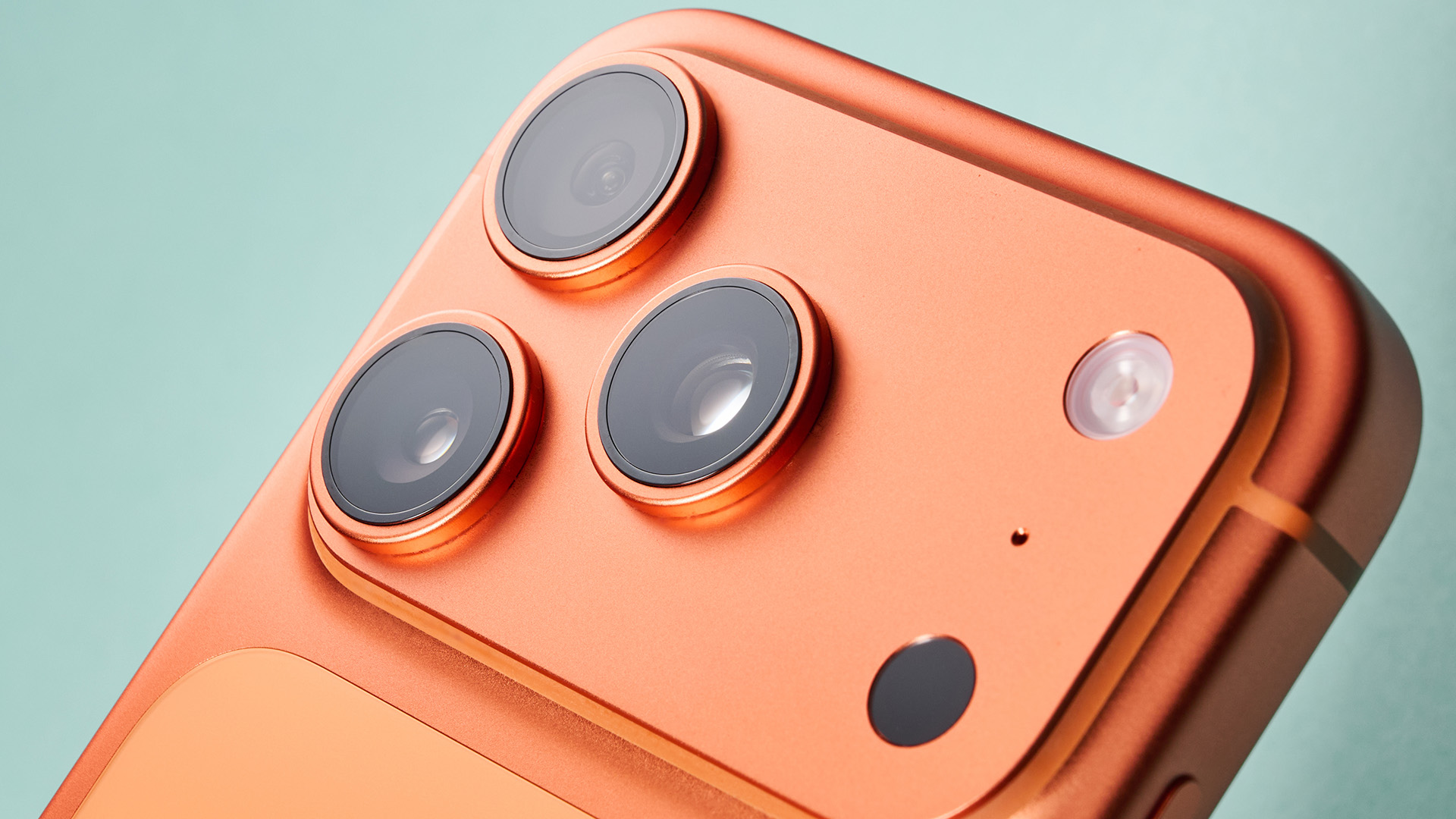 Apple iPhone 17 Pro in cosmic orange on green background