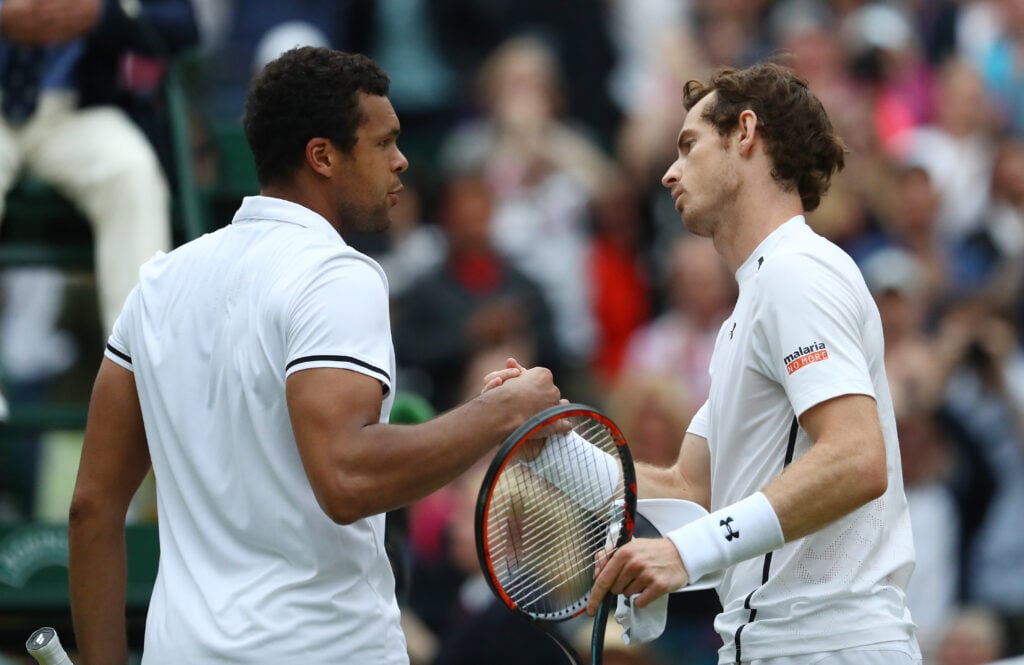 Andy Murray of Great Britain shakes hands with Jo-Wilfried Tsonga of France following victory in the Men's Singles Quarter Finals match on day nine of the Wimbledon Lawn Tennis Championships at the All England Lawn Tennis and Croquet Club.