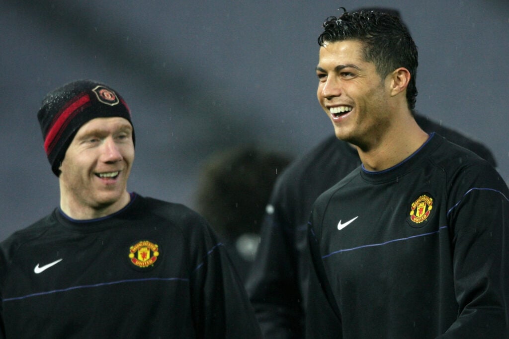 Paul Scholes and Cristiano Ronaldo of Manchester United laugh during a training session at the International Stadium Yokohama